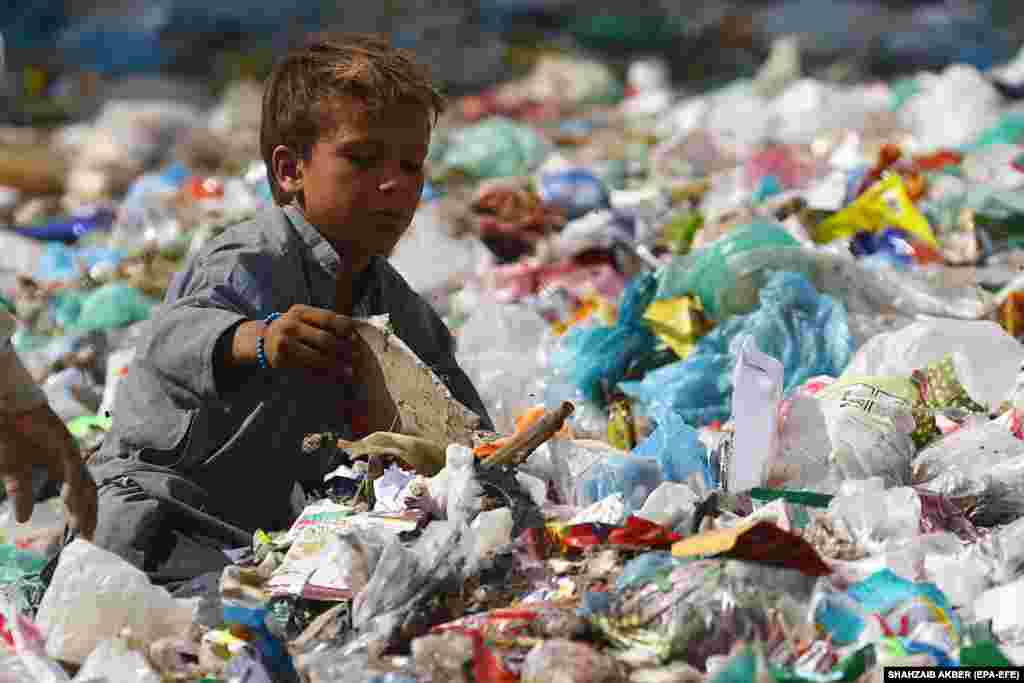 A boy collects recyclable waste from a dump on the outskirts of Karachi, Pakistan. (epa-EFE/Shahzaib Akber)