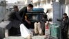 Men carry an injured person to the hospital after attacks mortar attacks in Kabul on March 7. 