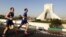 Runners in Iran's first international marathon pass Azadi Square in Tehran.