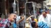 Iraq - Men refresh themselves under shower in street, Baghdad, undated