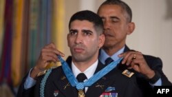 U.S. President Barack Obama presents retired U.S. Army Captain Florent Groberg with the Medal of Honor during a ceremony in the East Room of the White House in Washington on November 12.