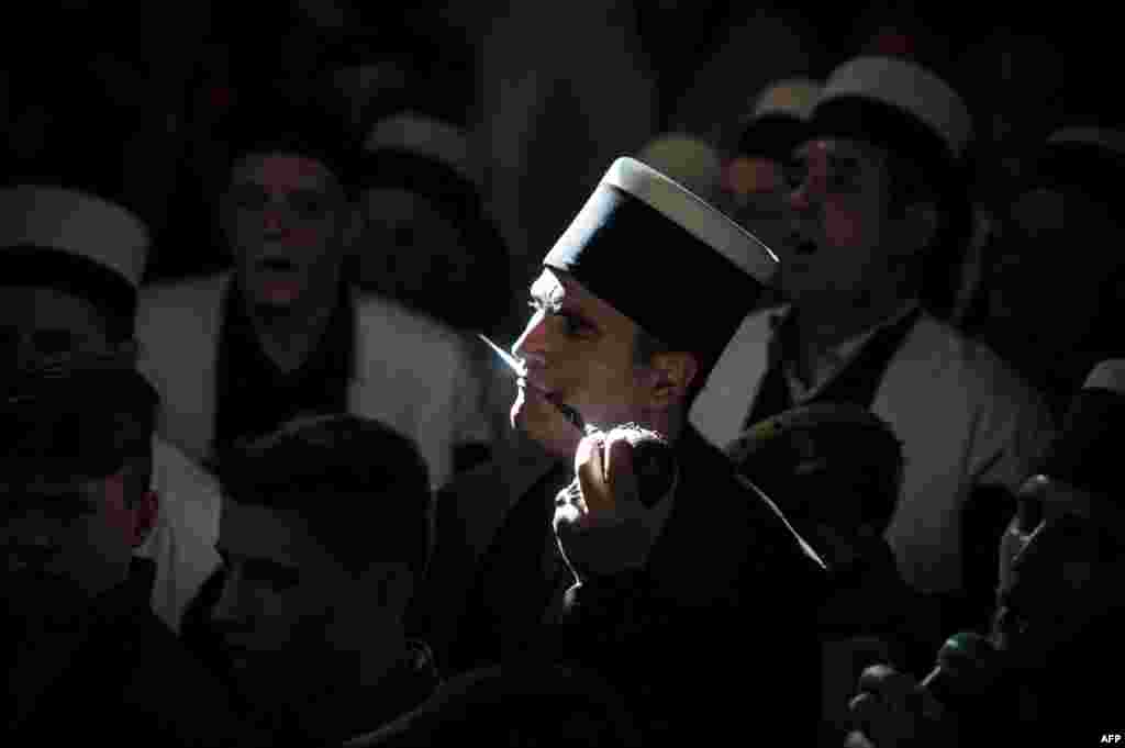 Kosovar dervishes pierce their cheeks with small metal rods as they take part in a ceremony marking Norouz celebrations in the town of Prizren. (AFP/Armend Nimani)