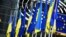 The flags of Ukraine and the European Union hang together outside the European Parliament in Brussels.