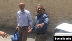 Ahmad Zeidabadi (left), a prominent Iranian journalist and political activist,on his release from prison last week. he was reportedly