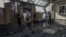 A dead body is carried out of a house in the Ukrainian village of Myla, near Kyiv, following a detonation at a local warehouse after a Russian strike on August 29.