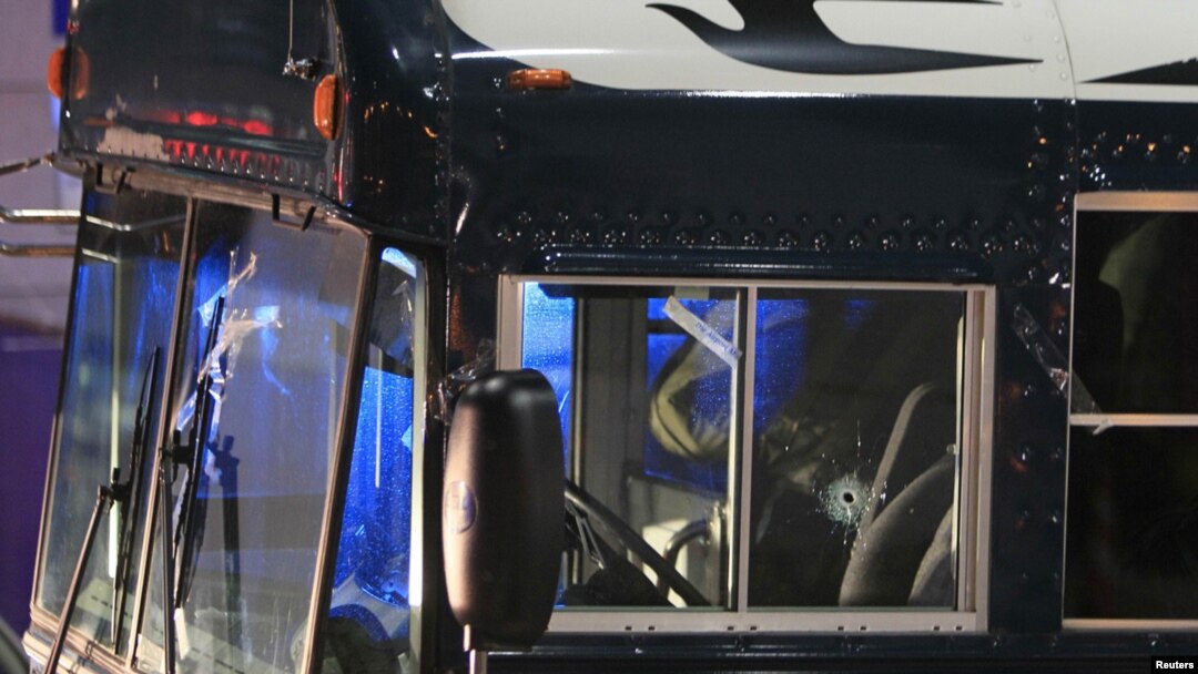 A bullet hole is seen in the window of the driver seat of a US Army bus outside the airport in Frankfurt.