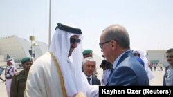 FILE PHOTO -- Turkish President Tayyip Erdogan is welcomed by Emir of Qatar Sheikh Tamim Bin Hamad Al-Thani in Doha, Qatar, July 24, 2017