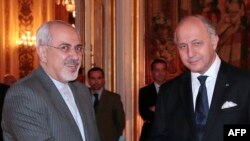 French Foreign Minister Laurent Fabius (right) welcomes his Iranian counterpart, Mohammad Javad Zarif, to the Foreign Ministry. 