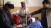 Relatives tend to an injured blast victim at a hospital in Kurram tribal district on January 30.