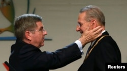 Outgoing International Olympic Committee President Jacques Rogge (right) congratulates Thomas Bach of Germany after he was elected the ninth president of the IOC during a vote in Buenos Aires on September 10