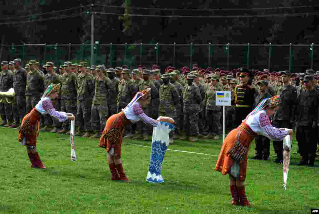 Ukrainian folk dancers perform for Ukrainian and U.S. servicemen in a ceremony for joint exercises between the two countries in Ukraine's Lviv region. The annual Rapid Trident exercises involve 1,800 soldiers from 18 countries. (AFP/Yuriy Dyachyshyn)