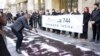 Serbia - Activists in Belgrade spread a banner with the names of the killed Kosovo Albanians, whose remains were found in a mass grave in Batajnica. Belgrade, 26. March 2019.