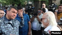 Armenia - Vladimir Gasparian (L), the chief of the Armenian police, argues with a protester in Yerevan, 26Jun2015.