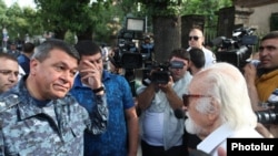 Armenia - Vladimir Gasparian (L), the chief of the Armenian police, argues with a protester in Yerevan, 26Jun2015.