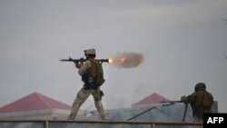 An Afghan Quick Reaction Force (QRF) soldier fires a rocket-propelled grenade (RPG) launcher during an operation near the Indian consulate in Mazar-e Sharif on January 4, 2016