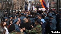 Armenia - Riot police confront anti-LGBT protesters outside the parliament building in Yerevan, April 8, 2019.