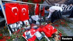 A man places flowers at the entrance of the Reina nightclub in Istanbul on January 3.