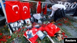 A man places flowers at the entrance of the Reina nightclub where at least 39 people were killed in a gun attack in the early hours of News Year's day (file photo). 