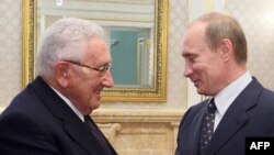 Former U.S. Secretary of State Henry Kissinger meets Russian Prime Minister Vladimir Putin during a visit to Moscow on March 19.