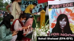 People attend a candlelight vigil in remembrance of Noor Mukadam, who was murdered in Islamabad in July 2021.