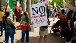 Demonstrators hold signs at a rally condemning the execution of political prisoners in Iran, in Washington on May 16.