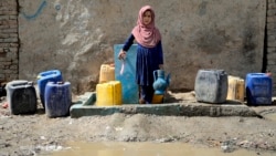 An Afghan child collects water from a public water pump in Kabul (file photo)