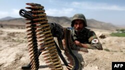 An Afghan National Army soldier holds a position while patrolling the village of But Khak on the outskirts of Kabul (file photo). 