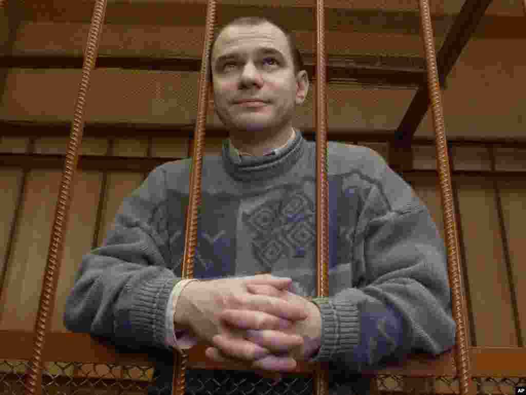 Russian nuclear scientist Igor Sutyagin stands behind bars on April 7, 2004, as he listens to a guilty verdict in a Moscow courtroom. Sutyagin was among four convicted spies pardoned by Medvedev to be exchanged for 10 Russians accused of spying in the United States.