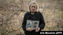 Lusine Margarian holds photographs of her son Hayk, 23, an Armenian soldier who went missing during last years war with Azerbaijan, in Yerevan on March 7.