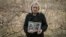 Lusine Margarian holds photographs of her son Hayk, 23, an Armenian soldier who went missing during last years war with Azerbaijan, in Yerevan on March 7.