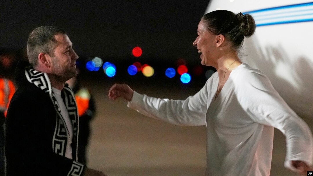 US-Russian dual national Ksenia Karelina greets her fiancé, professional boxer Chris van Heerden, as she arrives Thursday, April 10, 2025, at Joint Base Andrews, Md.