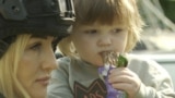 White Angel officer Olena Stavytska helps evacuate a child and its mother from the Sumy region. 