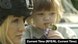 White Angel officer Olena Stavytska helps evacuate a child and its mother from the Sumy region. 