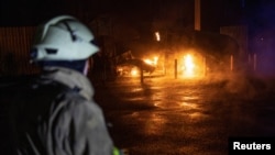 A rescuer looks on at the site of a Russian missile strike in the village of Kotlyary outside Kharkiv on April 22.