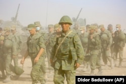 Tajik soldiers march during a military drill near their country’s border with Afghanistan in August 2021.