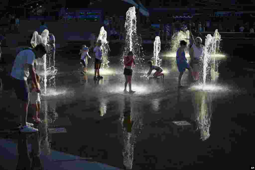 Russian children cool off in a fountain during a sweltering day in Moscow.
