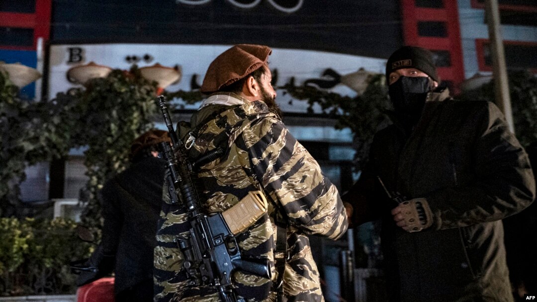 Afghan security personnel stand guard at the site of an alleged blast in the Dasht-e-Barchi neighborhood of Kabul on January 11. 