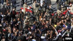 A scene from protests in Kerman, Iran showing security forces entangled with demonstrators, November 16, 2019