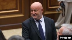 Armenia - Hovik Aghazarian talks to fellow pro-government deputies on the parliament floor, Yerevan.