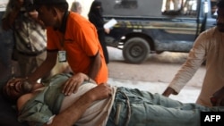 Pakistani rescuers take an injured man into a hospital after an explosion at a ship-breaking yard at Gadani.