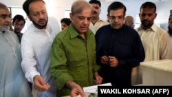 Shahbaz Sharif (center), the younger brother of ousted Pakistani Prime Minister Nawaz Sharif, casts his vote in the general elections.