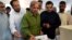 Shahbaz Sharif (center), the younger brother of ousted Pakistani Prime Minister Nawaz Sharif, casts his vote in the general elections.