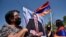 ARMENIA -- A supporter of Armenian opposition leader Gagik Tsarukian holds its portrait during a unauthorized rally close to National Secuirury Service headquarter in Yerevan, June 14, 2020