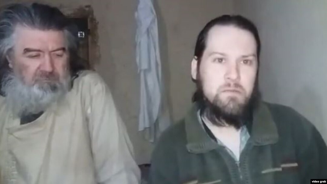 The two Moldovan pilots are seen in an undated video released by the Taliban.