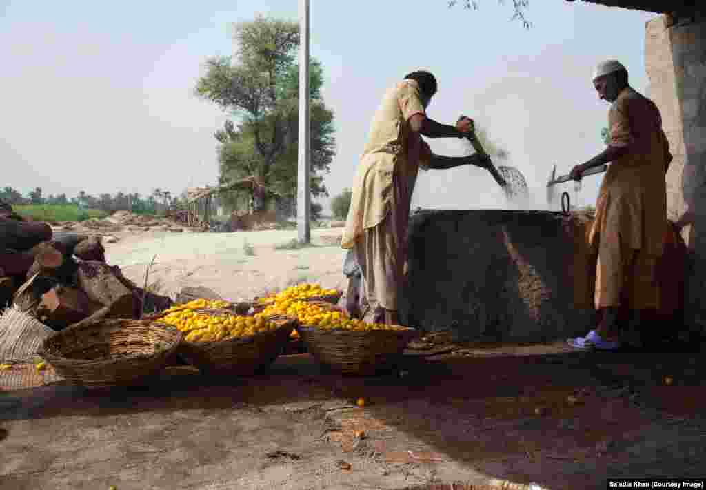 Dates are cooked in a giant wok, which is embedded in a makeshift furnace. The cook, Mohammad Nazir, has traveled from Kashmore, a town in Pakistan&#39;s southern Sindh Province. He is a specialist date cook and is paid $20 per day. A measured amount of sodium bicarbonate is added to the wok.