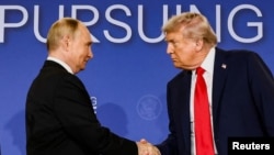 U.S. President Trump and Russian President Putin shake hands following their meeting to discuss the war in Ukraine in Anchorage, Alaska, on August 15.
