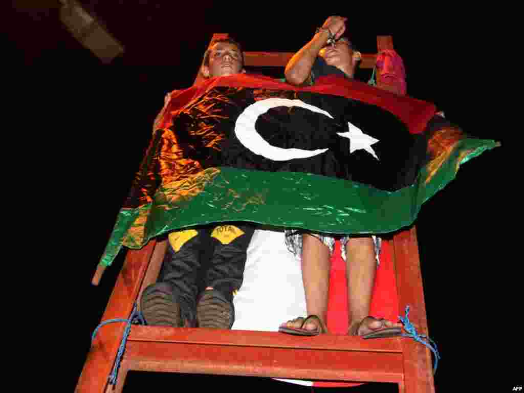 People in Tajura, a suburb of Tripoli, celebrated in the early morning after rebels seized swathes of the capital including the symbolic Green Square.