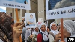 Kurdish women hold placards showing jailed journalists at the start of the trial in Istanbul in September of 44 reporters with suspected links to rebels from the Kurdistan Workers Party.