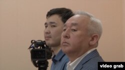 Seitqazy Mataev (right) and his son Aset in court in Astana (file photo)