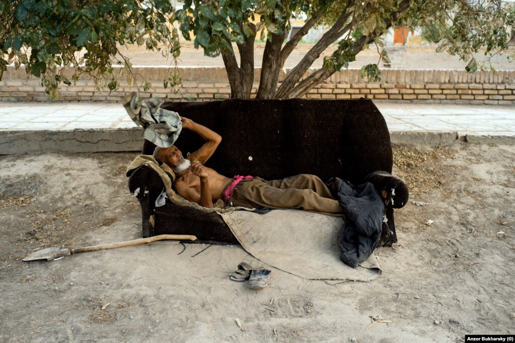 A man rests during a scorching-hot day in the courtyard of his house in Khiva.